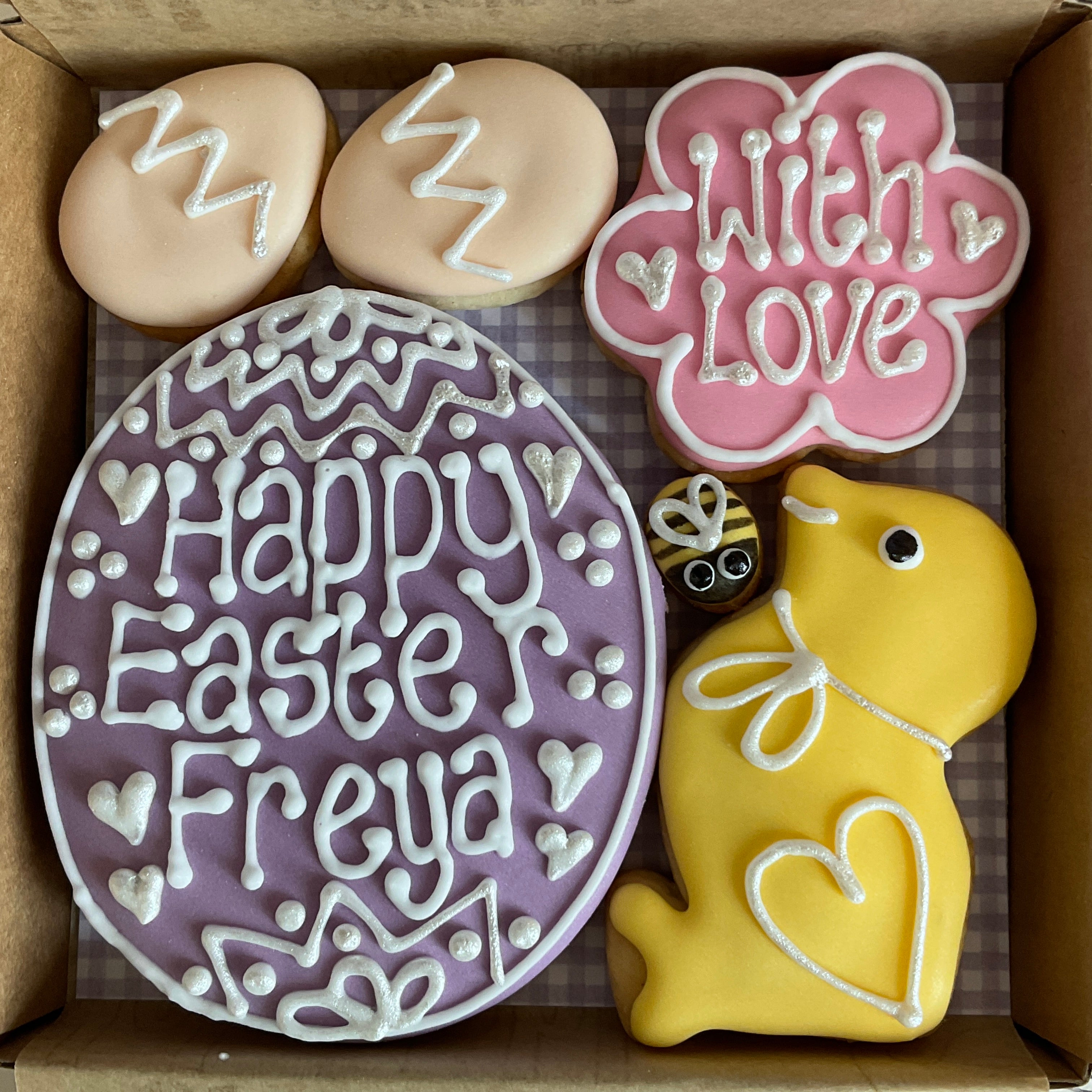 Decorated Easter cookies in shape of Easter egg and Easter chick in purple colour