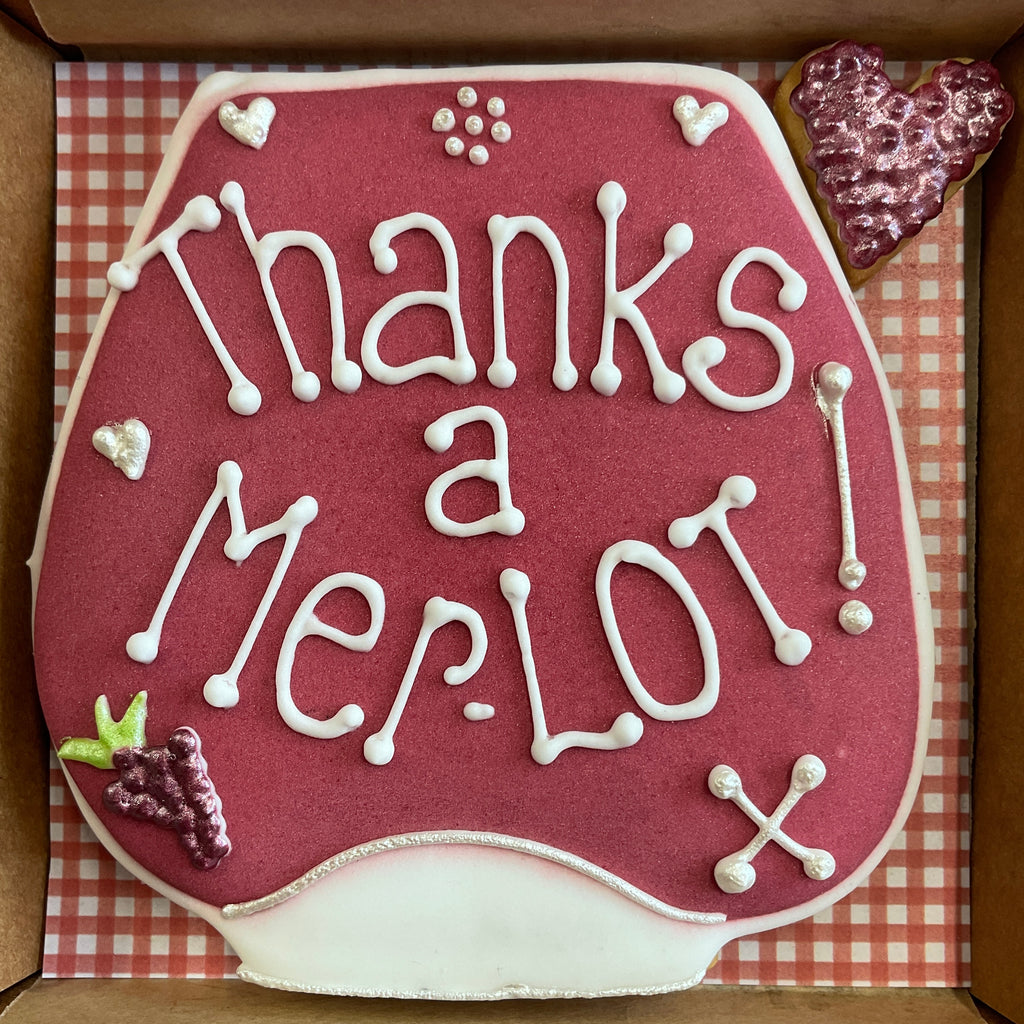 A delicious red wine stemless wineglass cookie box with Thanks a merlot iced on the main biscuit